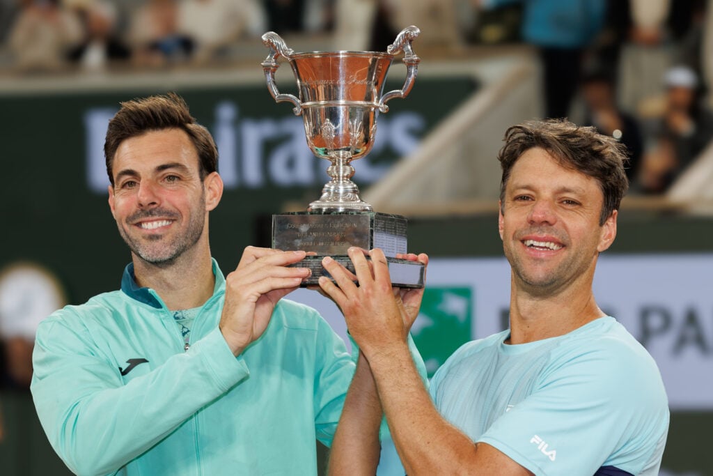 Marcel Granollers and Horacio Zeballos posing with the Roland Garros title in 2026.