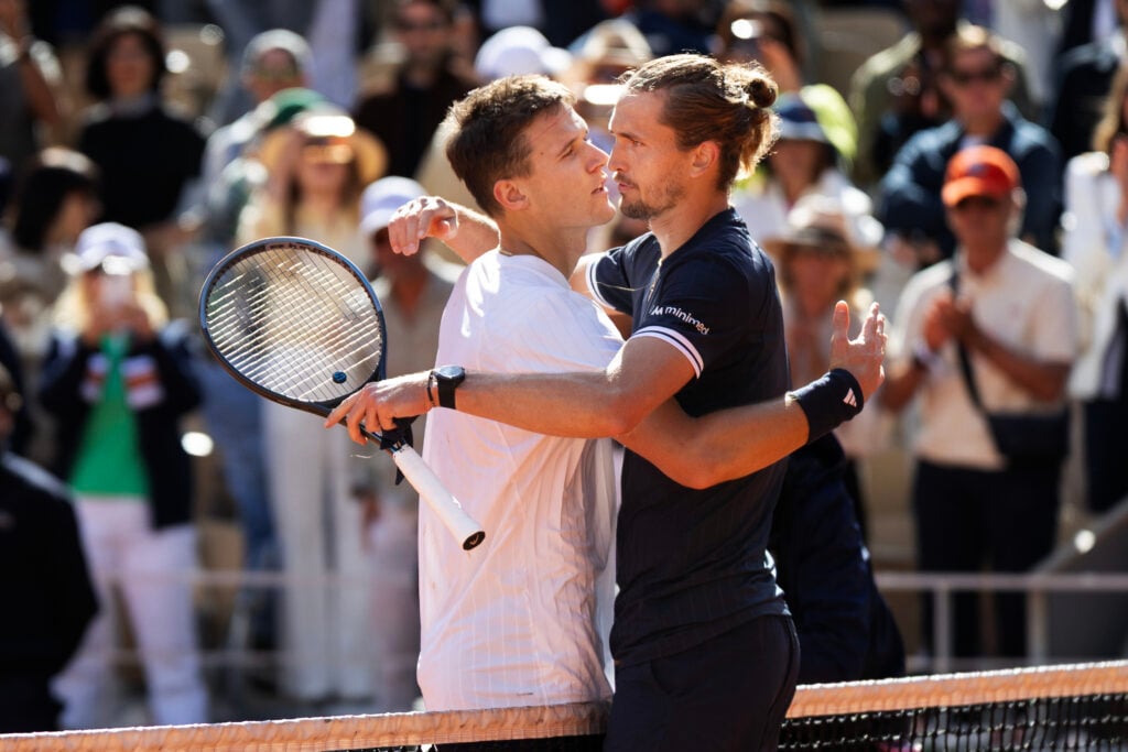 Jakub Mensik and Alexander Zverev embrace after their Roland Garros semi-final match.