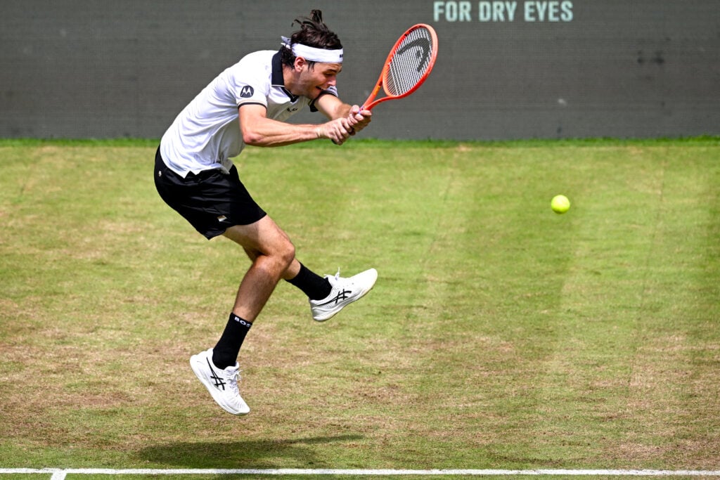 US' Taylor Fritz returns the ball to Hungary's Fabian Marozsan during their men's singles round of 16 tennis match of the Halle Open ATP tennis tournament in Halle, western Germany, on June 18, 2026.