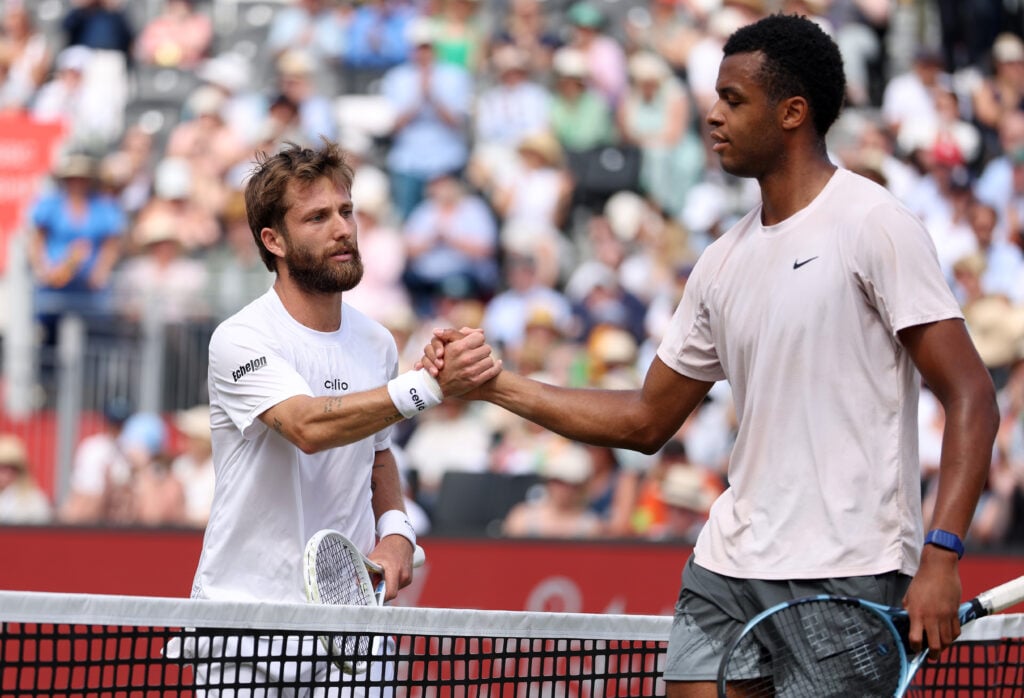 Corentin Moutet and Giovanni Mpetshi Perricard shake hands after their first-round match at Queen's.