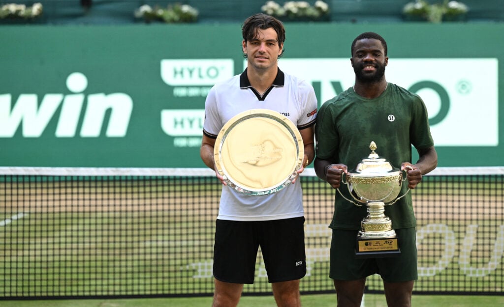 Winner Frances Tiafoe (R) of the US and second placed, his compatriot Taylor Fritz, pose for a picture with their trophies after their men's singles final match of the Halle Open ATP tennis tournament in Halle, western Germany, on June 21, 2026.