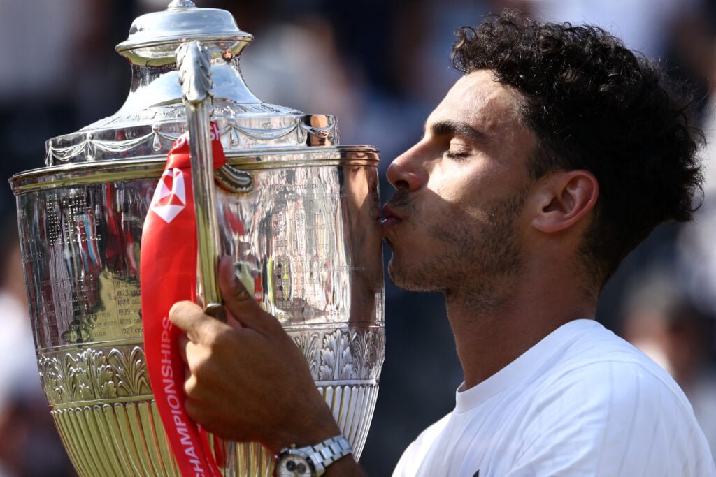 Argentina's Francisco Cerundolo poses for photographers with the winners trophy after his victory over US player Tommy Paul during the men's singles final tennis match on day six of the ATP HSBC Championships at Queen's Club in west London on June 21, 2026.