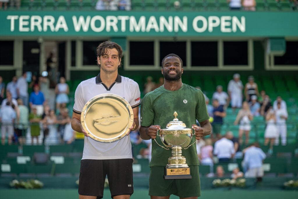 Taylor Fritz and Frances Tiafoe pose with trophies after the 2026 Halle Open final.