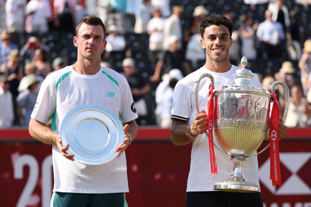 Runner-Up Tommy Paul of the United States and Winner Francisco Cerundolo of Argentina pose for a photo with their trophies following the Men's Singles final match on Day Fourteen of the HSBC Championships at The Queen's Club on June 21, 2026 in London, England.