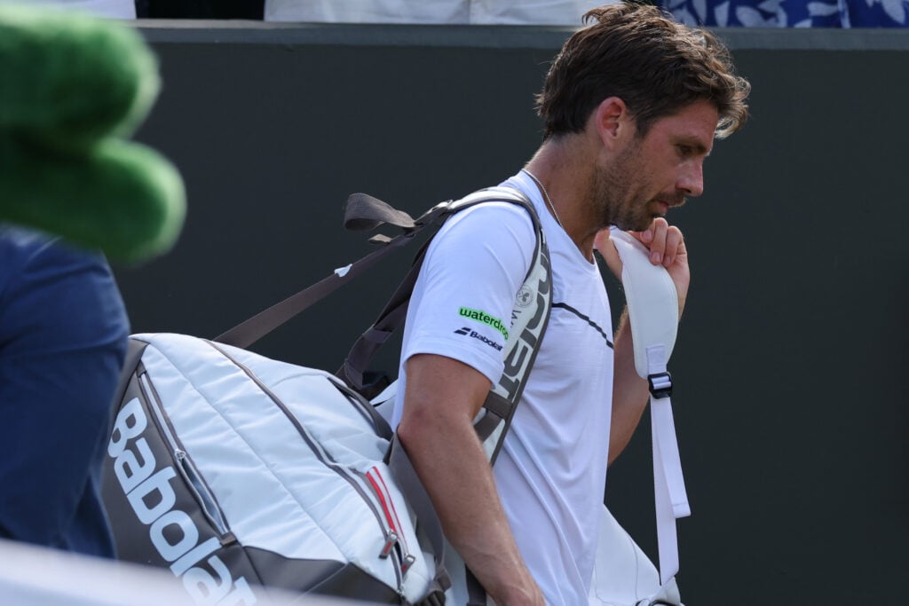 Cameron Norrie walks off court after losing in the first round of Wimbledon.