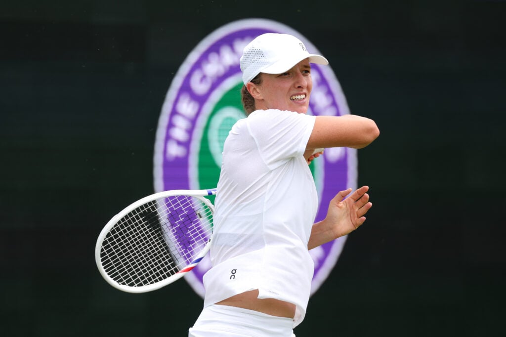 Iga Swiatek hitting a forehand in practice at Wimbledon in 2026.