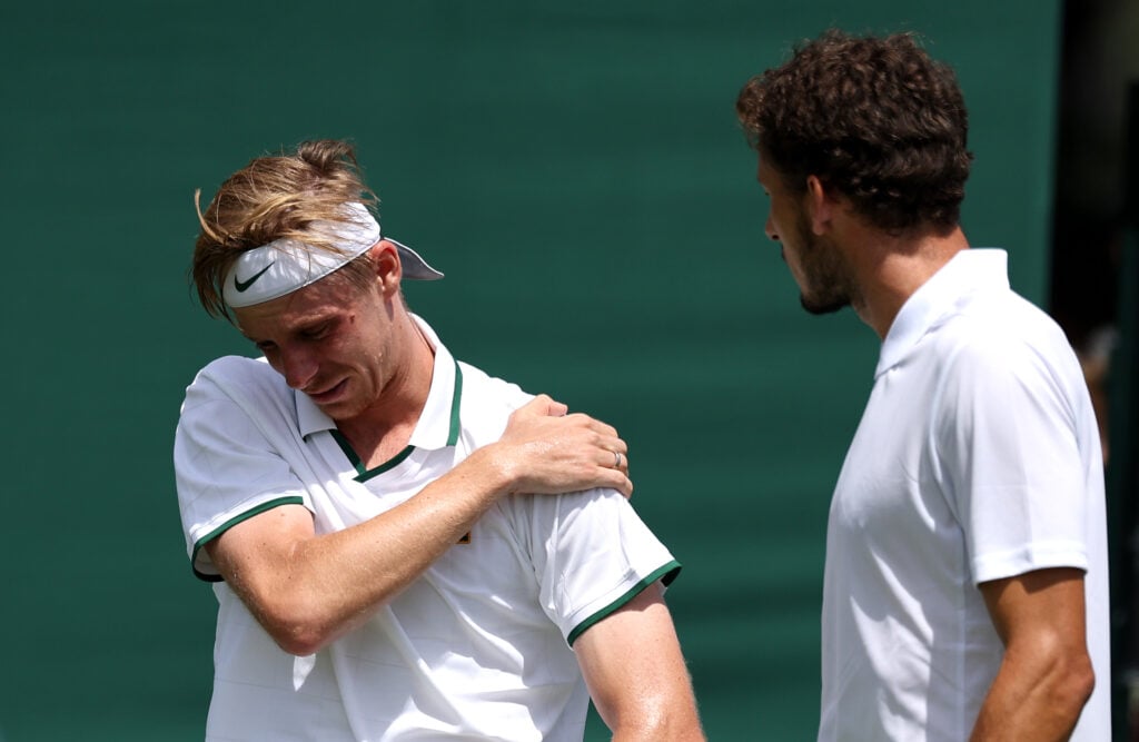 Pablo Carreno Busta exchanges with Denis Shapovalov at Wimbledon in 2026.