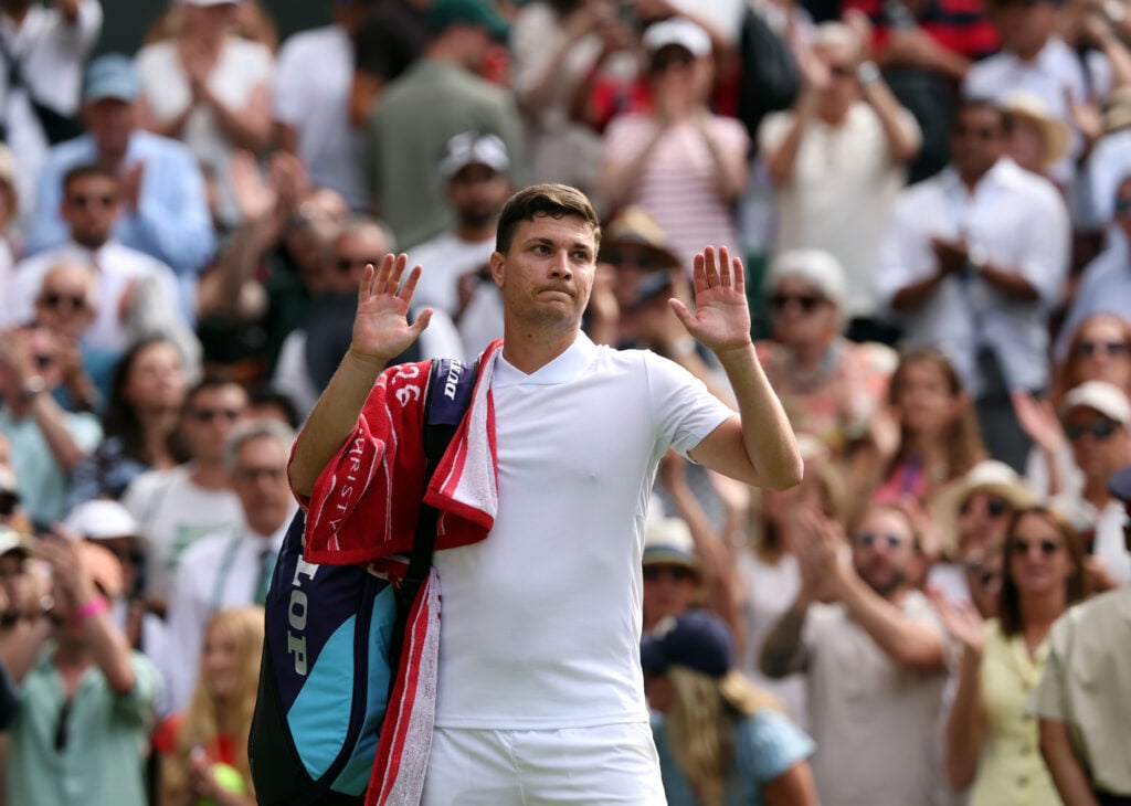 Miomir Kecmanovic reacts after losing to Jannik Sinner at Wimbledon in 2026.
