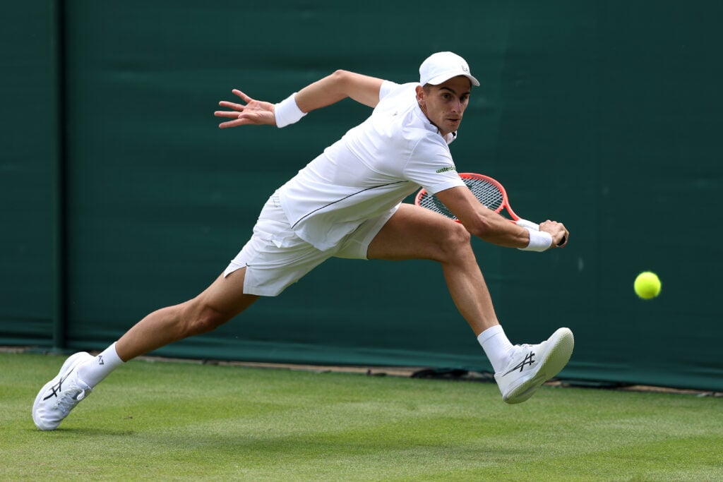 Matteo Arnaldi of Italy plays a backhand against Quentin Halys of France during their Gentlemen's Singles first round match on day two of The Championships Wimbledon 2026 at All England Lawn Tennis and Croquet Club on June 30, 2026 in London, England.