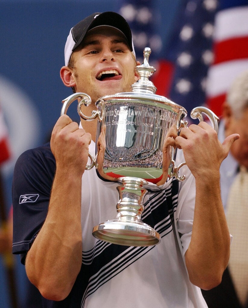 Andy Roddick of the United States holds the trophy after defeating Juan Carlos Ferrero of Spain, 6-3, 7-6 (7/2), 6-3, in the men's finals, 07 September, 2003, at the US Open tennis championships in Flushing Meadows, NY.