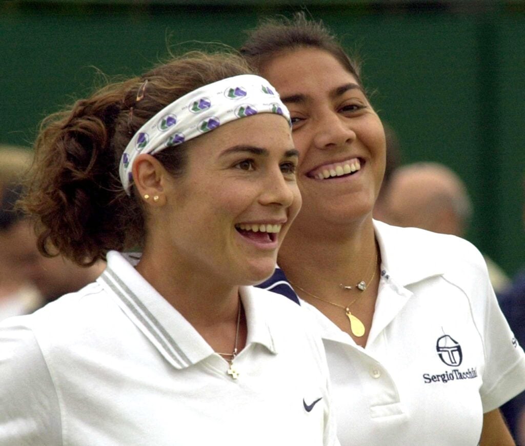 Spain's Virginia Ruano Pascual (L) and her partner Paola Suarez of Argentina (R) smile after winning a point during their Women's Doubles 3rd round match at the Wimbledon 2000 tennis tournament against Anke Huber of Germany and Barbara Schett of Austria 04 July 2000.