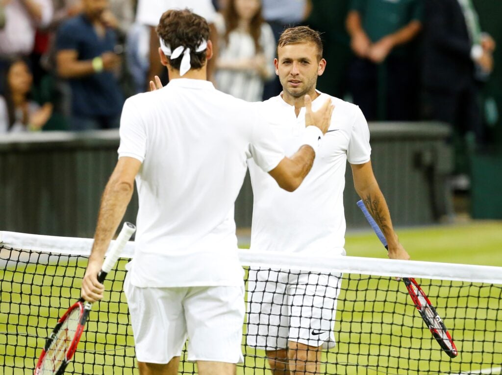 Daniel Evans of Great Britain (R) congratulates Roger Federer of Switzerland after being beaten by Federer in the men's singles on day five of the 2016 Wimbledon Championships at the All England Lawn and Croquet Club in London, United Kingdom on July 01 2016.