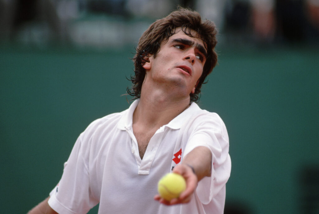 Guillermo Perez-Roldan prepares to toss the ball in the air on his serve in a tennis match at the 1988 French Open.