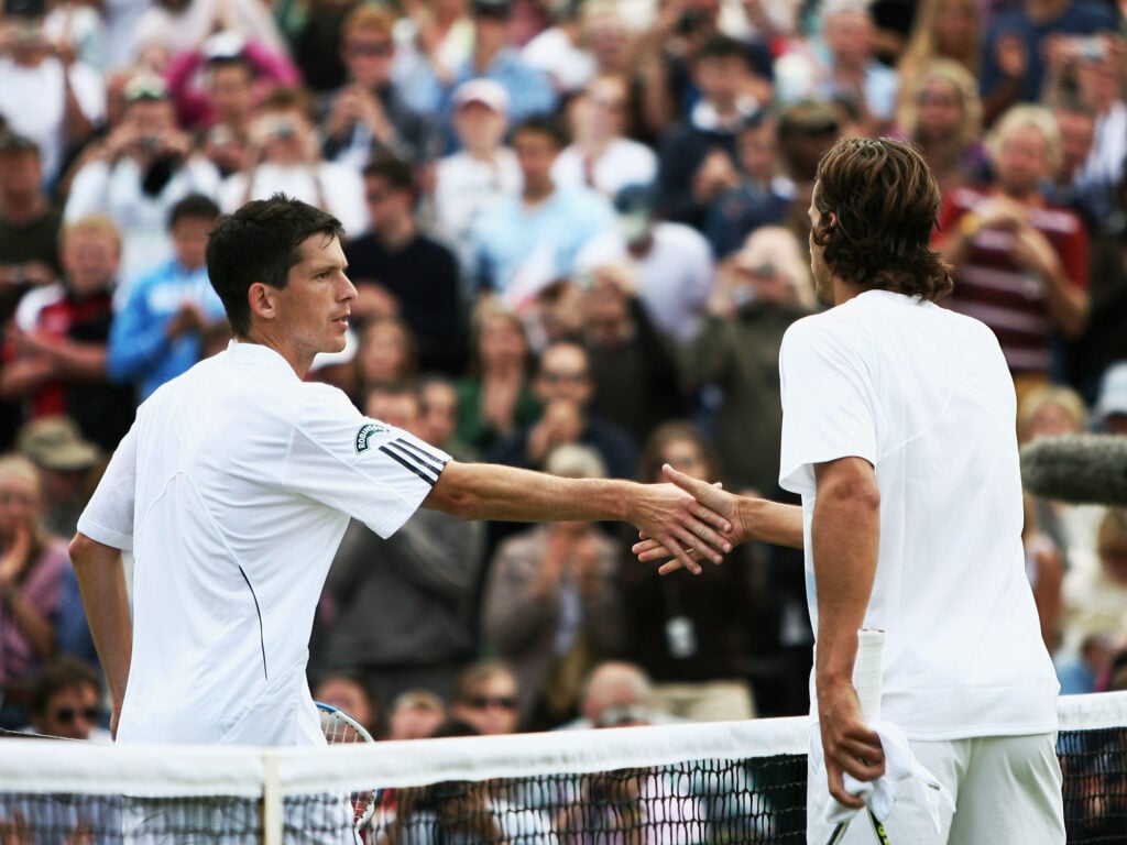 Tim Henman of Great Britain (L) shakes hands with Feliciano Lopez of Spain as he is knocked out of the tournamnet during their Men's Singles second round match during day four of the Wimbledon Lawn Tennis Championships at the All England Lawn Tennis and Croquet Club on June 28, 2007 in London, England.
