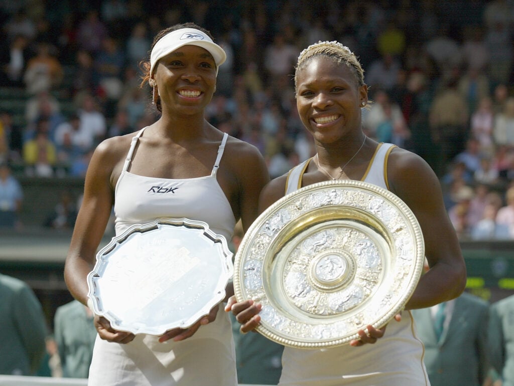 Serena Williams of the USA celebrates with the trophy after her victory against Venus Williams of the USA during the Womens Singles Final at the All England Tennis Championships at the All England Lawn Tennis Club, Wimbledon, England, on July 6, 2002.