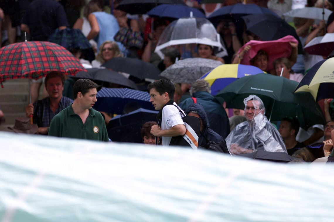 6 Jul 2001:  Tim Henman of Great Britain walks off as the rain come down in his match with Goran Ivanisevic of Croatia during the men's semi finals...