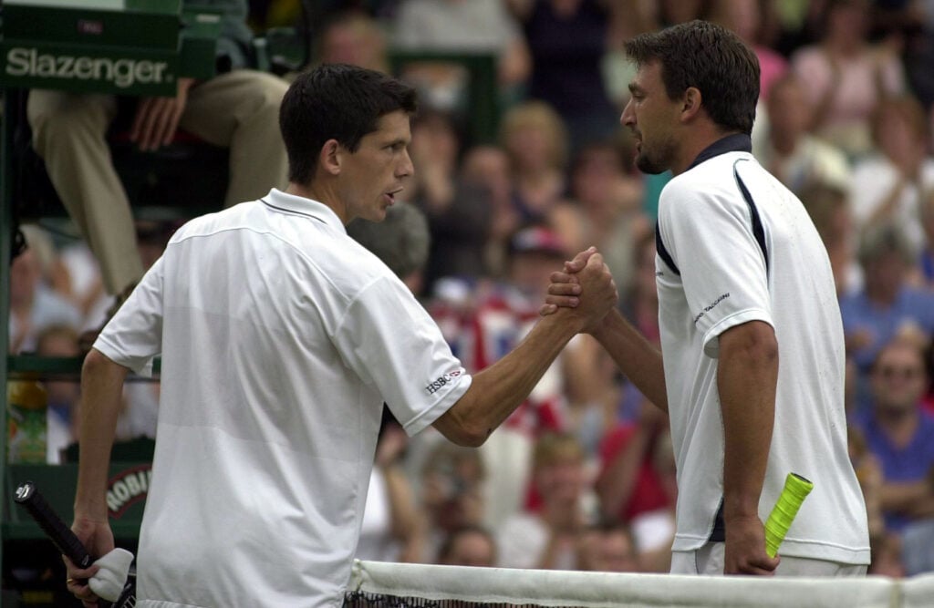 A dejected Tim Henman of Great Britain congratulates Goran Ivanisevic of Croatia on his victory during the men's semi-final's of The All England Lawn Tennis Championship at Wimbledon, London.