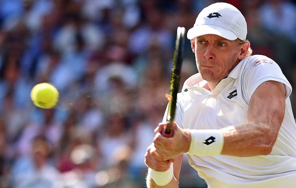 South Africa's Kevin Anderson returns against Switzerland's Roger Federer during their men's singles quarter-finals match on the ninth day of the 2018 Wimbledon Championships at The All England Lawn Tennis Club in Wimbledon, southwest London, on July 11, 2018.