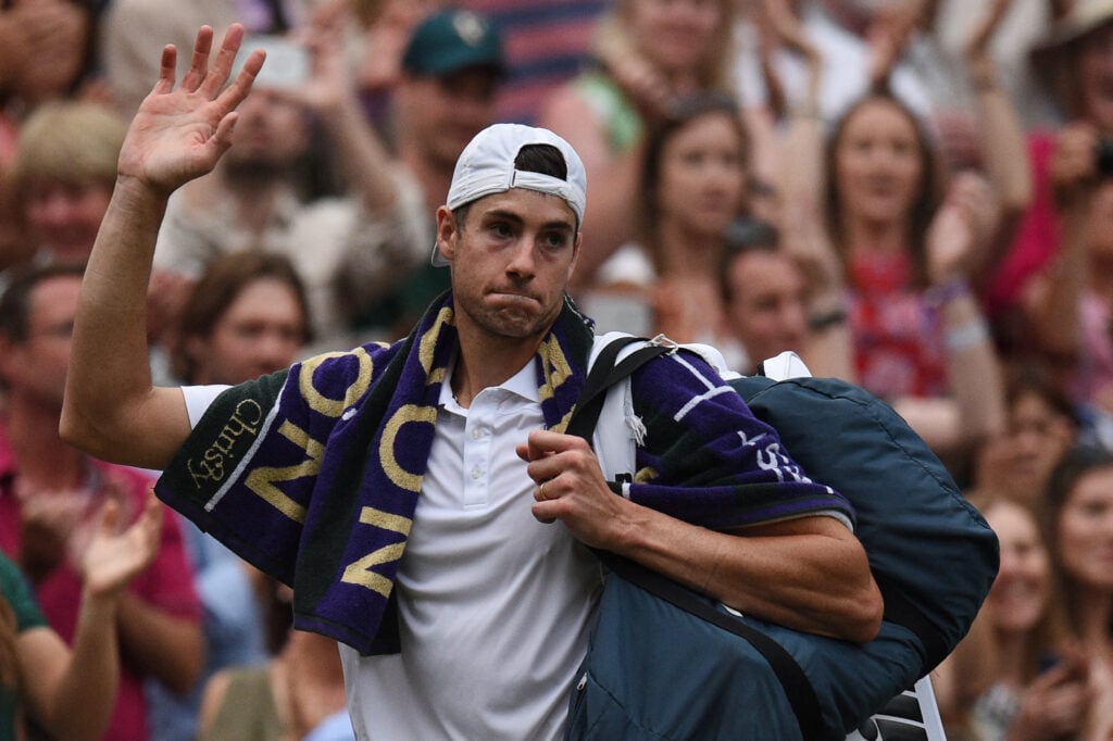 John Isner leaves the court after losing to Kevin Anderson in the 2018 Wimbledon semi-finals.