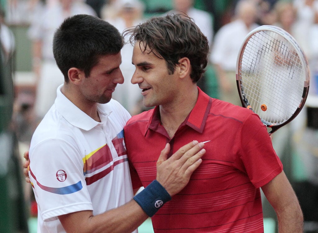 Switzerland's Roger Federer (R) reacts after winning over Serbia's Novak Djokovic during a semi final at the French Open tennis championship at the Roland Garros stadium, on June 3, 2011, in Paris.