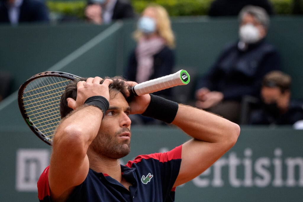Pablo Andujar reacts after beating Roger Federer at the 2021 Geneva Open.
