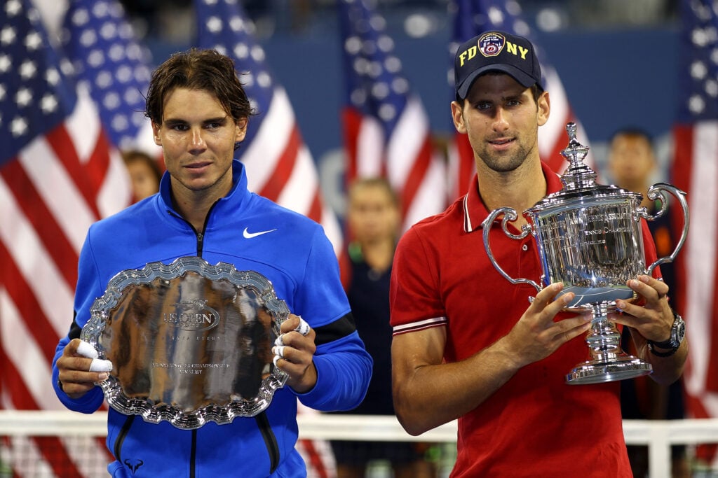 Novak Djokovic of Serbia holds up the winner's the trophy as Rafael Nadal (L) of Spain holds up the runner up award after Djokovic defeated Nadal during the Men's Final on Day Fifteen of the 2011 US Open at the USTA Billie Jean King National Tennis Center on September 12, 2011 in the Flushing neighborhood of the Queens borough of New York City.