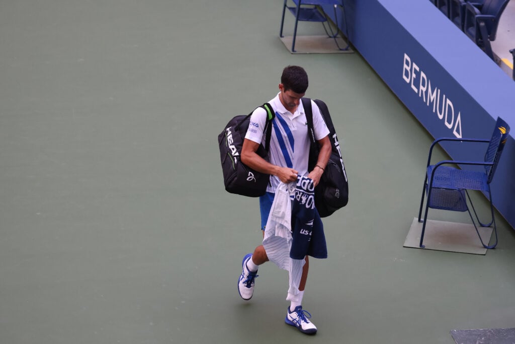 Novak Djokovic walks off court after being disqualified at the 2020 US Open.