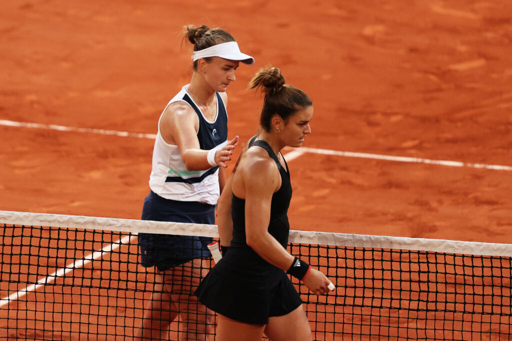 Barbora Krejcikova of The Czech Republic consoles Maria Sakkari of Greece after shaking hands at the net after their Semi-Final Women's Singles match during Day Twelve of the 2021 French Open at Roland Garros on June 10, 2021 in Paris, France.