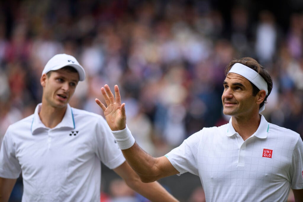 Hubert Hurkacz and Roger Federer pictured after their quarter-final match at Wimbledon in 2021.