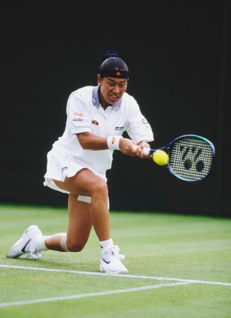 Kimiko Date from Japan plays a double handed forehand return against Mary Pierce of France during their Women's Singles First Round match at the Wimbledon Lawn Tennis Championship on 24th June 1996 at the All England Lawn Tennis and Croquet Club in Wimbledon, London, England. Kimiko Date won the match 3 - 6, 6 - 3, 6 - 1.