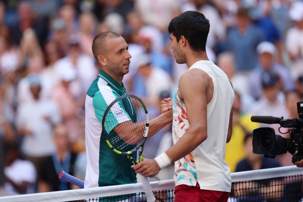 Daniel Evans (L) of Great Britain shakes hands with Carlos Alcaraz of Spain after being defeated in their Men's Singles Third Round match on Day Six of the 2023 US Open at the USTA Billie Jean King National Tennis Center on September 02, 2023 in the Flushing neighborhood of the Queens borough of New York City.
