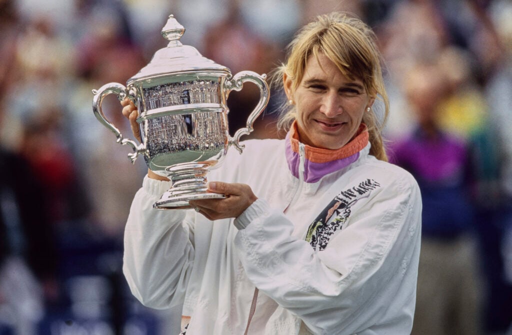 German tennis player Steffi Graf lifts the trophy after she won the Women's Singles final of the US Open tennis tournament, at the USTA National Tennis Center in Flushing Meadows-Corona Park in Queens, New York City, New York, 11th September 1993. Graf won the match 6-3, 6-3, beating Czech tennis player Helena Sukova.