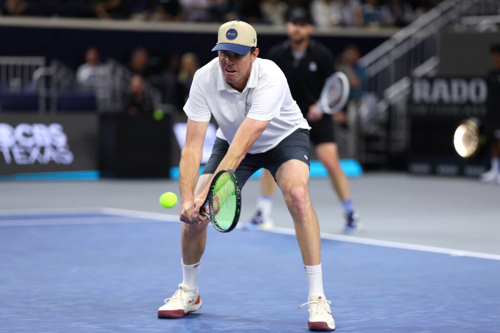 Sam Querrey of the United States plays a shot to John Isner and John McEnroe of the United States in the All-American Classic during the 2026 Dallas Open at The Ford Center at The Star on February 07, 2026 in Frisco, Texas.