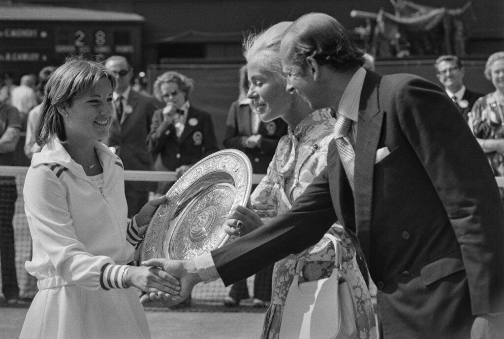 American tennis player Chris Evert is presented with the Venus Rosewater Dish by British Royals Katharine, Duchess of Kent and her husband, Prince Edward, Duke of Kent, after winning the women's singles final at the Wimbledon Championships, at the All England Lawn Tennis and Croquet Club in Wimbledon, London, England, 3rd July 1976. Evert won the game, defeating Australian tennis player Evonne Goolagong Cawley 6-3, 4-6, 8-6.