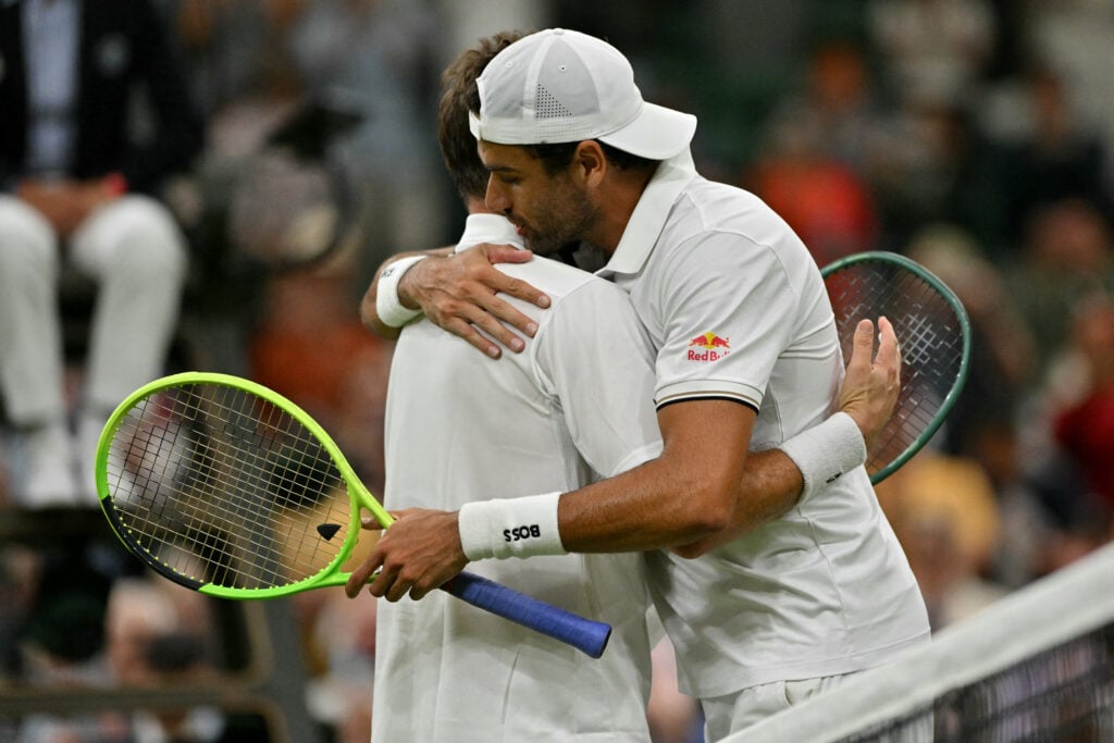 Matteo Berrettini hugs Stan Wawrinka
