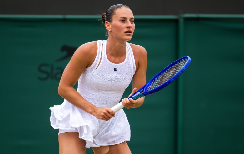 Marta Kostyuk in action against Emma Navarro at Wimbledon in 2026.