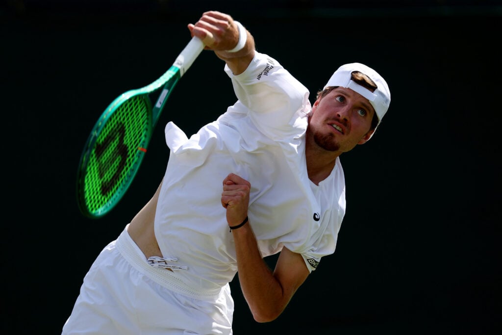 Toby Samuel of Great Britain serves against Jakub Mensik of Czechia during their Gentlemen's Singles first round match on day two of The Championships Wimbledon 2026 at All England Lawn Tennis and Croquet Club on June 30, 2026 in London, England.