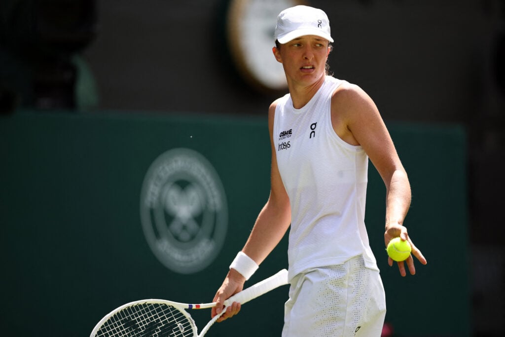 Iga Swiatek reacts during her match against Alexandra Eala at Wimbledon in 2026.