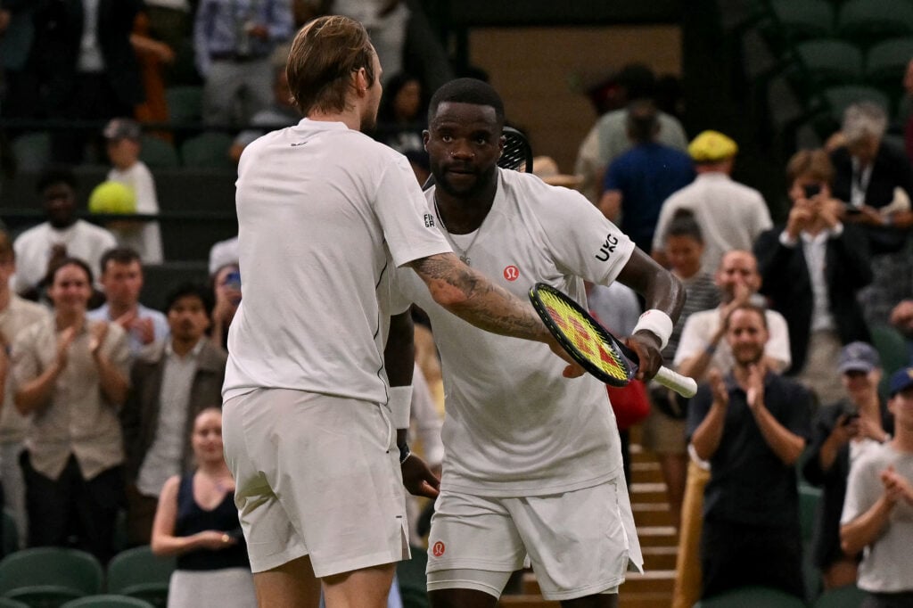 Alexander Bublik embraces Frances Tiafoe after beating him at Wimbledon in 2026.
