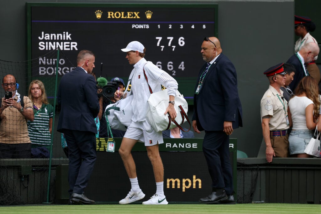 Jannik Sinner exits the court after winning his second-round match at Wimbledon.