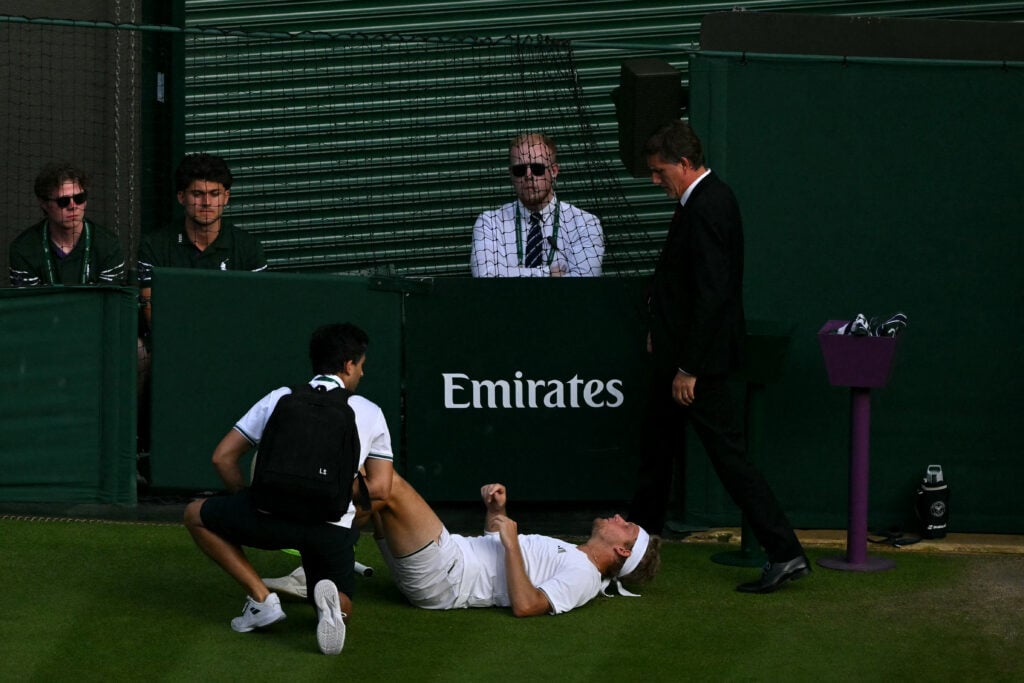 Alejandro Davidovich Fokina receiving medical attention during his match against Felix Auger-Aliassime at Wimbledon in 2026.