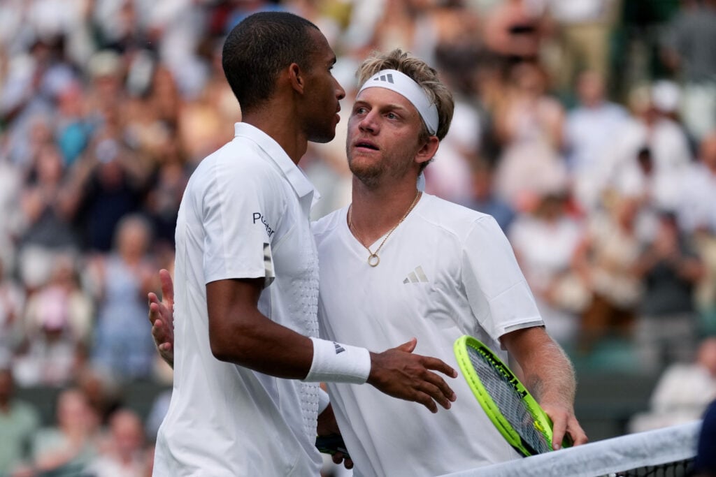 Felix Auger-Aliassime embraces Alejandro Davidovich Fokina after beating him at Wimbledon in 2026.