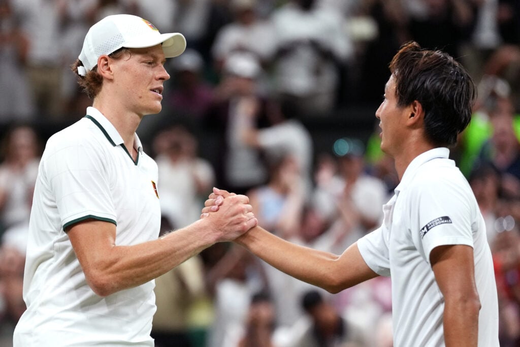 Jannik Sinner shakes hands with Shintaro Mochizuki after beating him at Wimbledon in 2026.