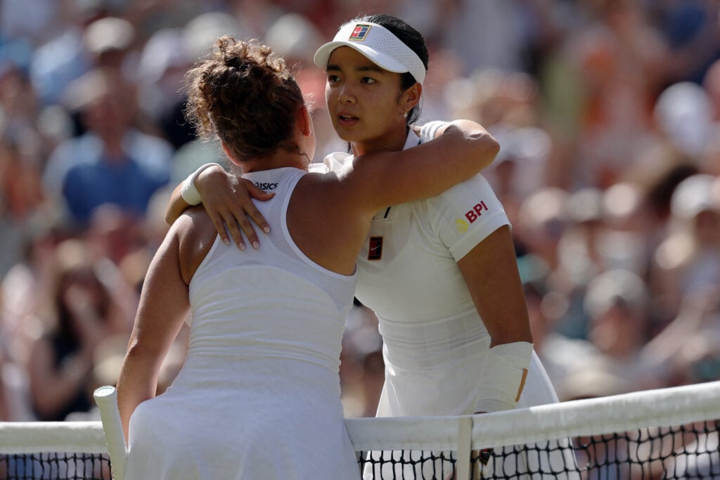 Jasmine Paolini hugs Alexandra Eala after beating her at Wimbledon in 2026.