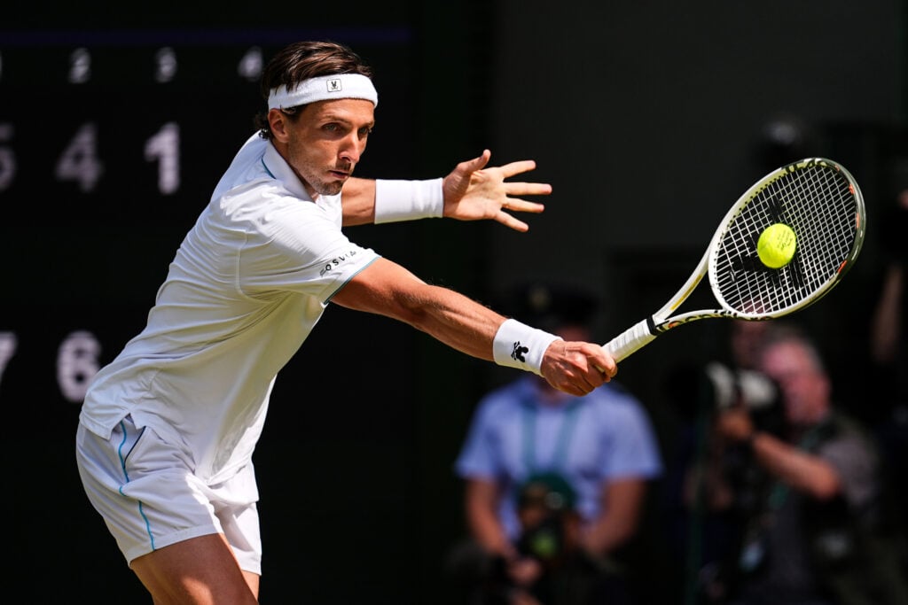 Arthur Rinderknech returns the ball during his Wimbledon third-round match against Novak Djokovic.