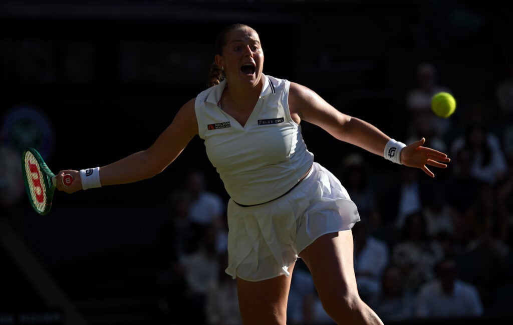 Jelena Ostapenko hits a forehand against Aryna Sabalenka at Wimbledon.
