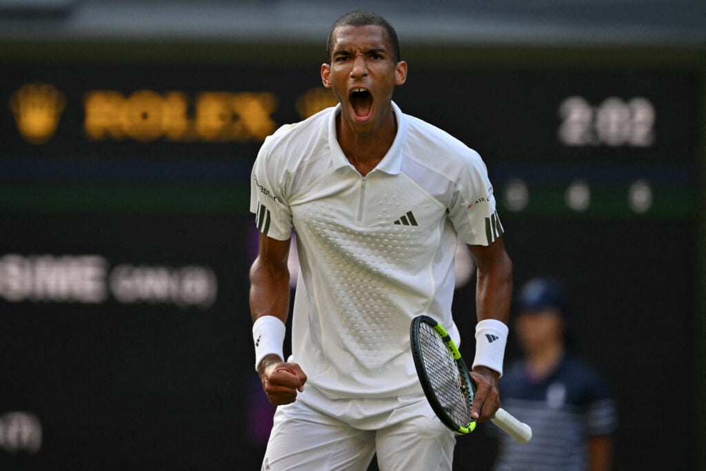 Felix Auger-Aliassime celebrates winning a set against Novak Djokovic at Wimbledon in 2026.