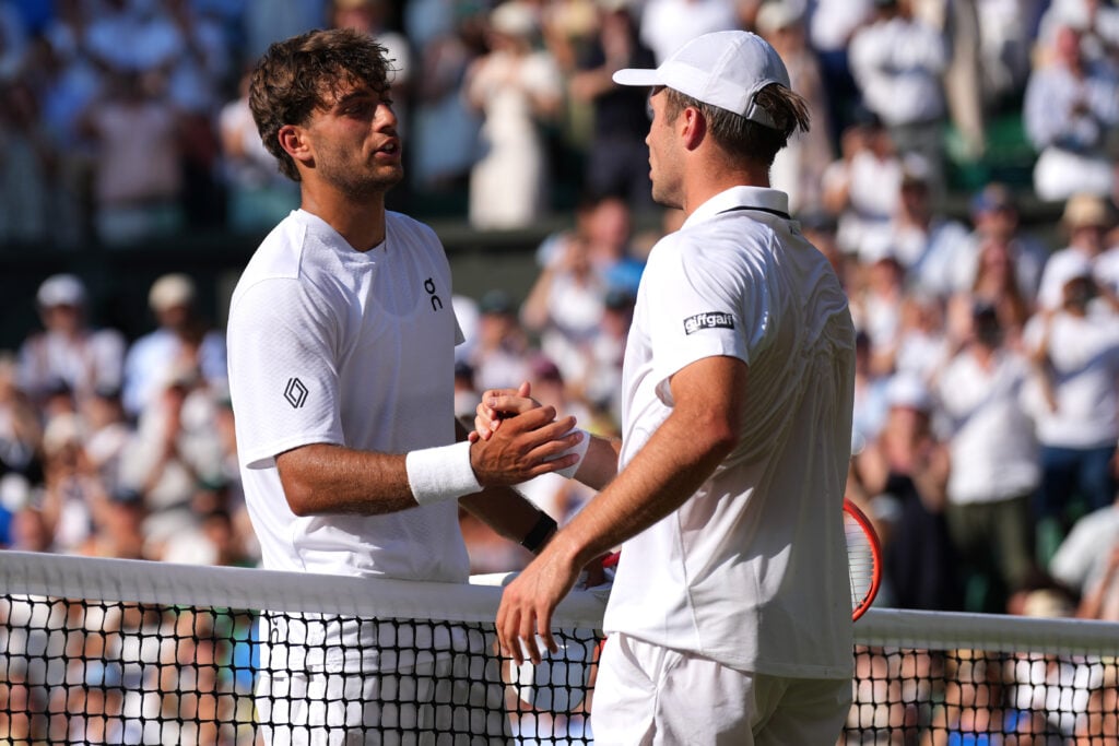 Arthur Fery shakes hands with Flavio Cobolli after beating him at Wimbledon in 2026.