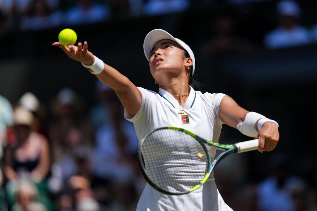 Alex Eala is pictured serving against Jasmine Paolini at Wimbledon