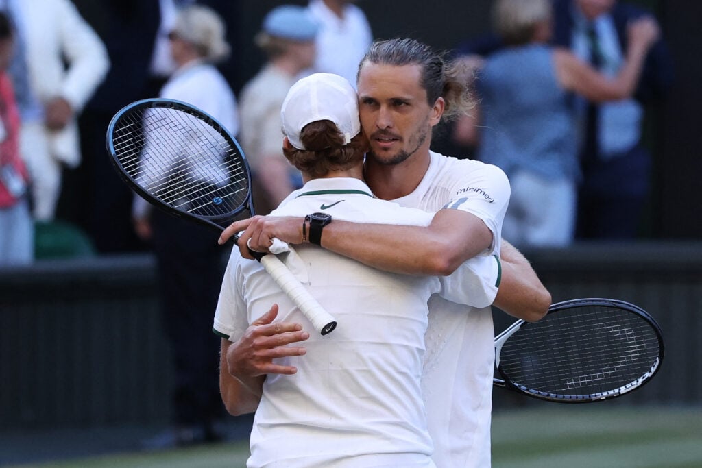 Jannik Sinner hugs Alexander Zverev after beating him at Wimbledon in 2026.
